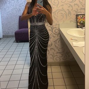 Channel your inner elegance with this stunning black ball gown. #ElegantAffair ✨